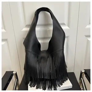 Close-up of black lychee grain faux leather handbag with long fringe tassel detail