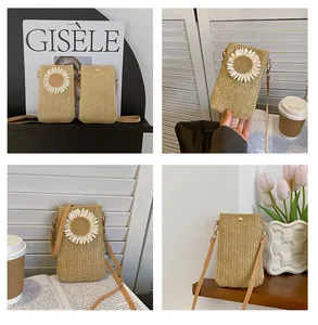 Macro detail of natural straw crossbody bag featuring sunflower applique and metal snap button