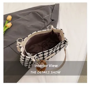 Interior view of houndstooth tote bag with brown lining and secure zipper pocket