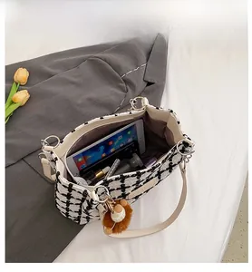Interior view of large capacity plaid tote bag showing ample space for a tablet and cosmetics