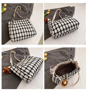 Detailed view of checkered wool tote bag showing texture, straps, and inner lining