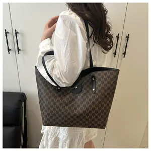 Large brown tote bag with M-letter pattern shown on shoulder for capacity and size detail