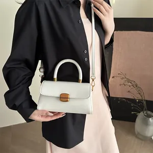 Elegant white crossbody square bag with gold hardware and top handle for women