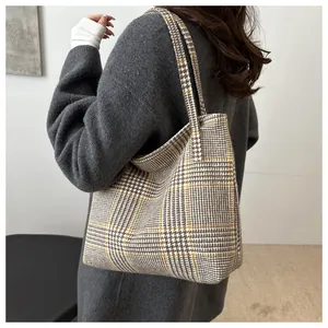 Detail of large check tote bag showing yellow and brown houndstooth knit fabric texture