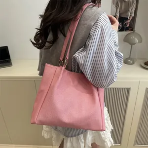 Pink woven canvas tote bag for women showing spacious interior and metal ring shoulder straps