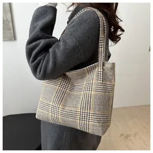 Detailed view of the checkered tote bag's fabric texture and minimalist retro style