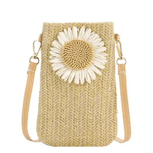 Stylish woven straw crossbody bag with white sunflower design and leather strap