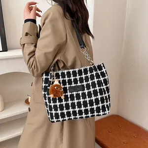 Classic black and white tweed plaid tote bag with chain strap and plush monster charm