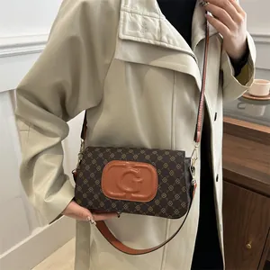 Vintage brown monogram handbag with orange G logo on shoulder strap for women