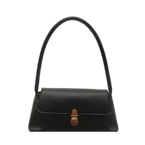 Elegant black minimalist shoulder bag with vintage bronze buckle and smooth leather finish