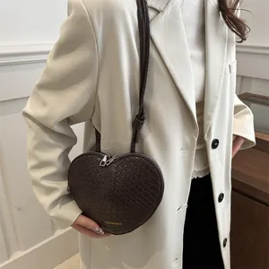 Minimalist heart-shaped crossbody bag in dark brown faux leather with crocodile texture