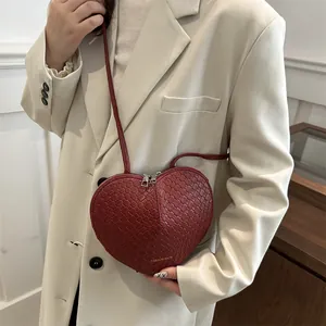 Red woven heart-shaped crossbody bag for women featured with fashion bag text on a blazer