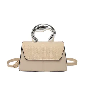 Minimalist beige crossbody bag with contrast weave texture and silver sculptural handle