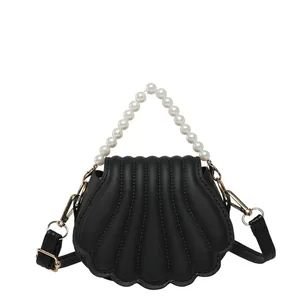 Chic black shell-shaped crossbody bag with wave texture and pearl handle accessory