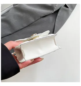 Detail showing side width and stitching of white quilted PU leather crossbody bag
