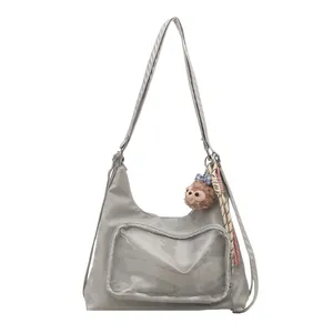 Gray large capacity ita bag with transparent PVC front pocket and plush monkey keychain