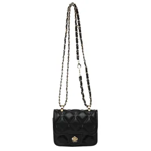 Black quilted mini crossbody bag with gold camellia buckle and leather chain strap