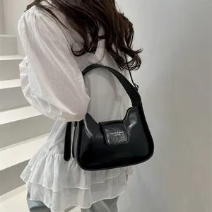 Chic black glazed leather half-moon shoulder bag with buckle for women's spring 2025
