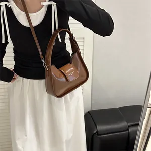 Chic brown leather Hobo shoulder bag for women with adjustable strap and buckle design