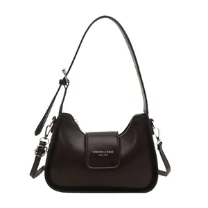 Glossy chocolate brown underarm bag with adjustable strap and silver logo lettering