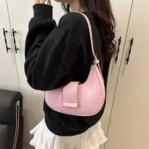 Pink minimalist crescent shoulder bag for women with leather strap and magnetic flap