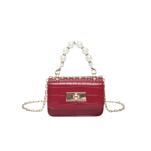 Red crocodile texture mini pearl handle handbag with gold chain strap on white background