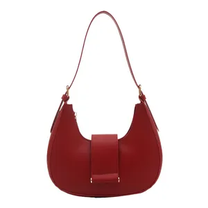 Minimalist red leather hobo shoulder bag with sleek curved design and gold hardware