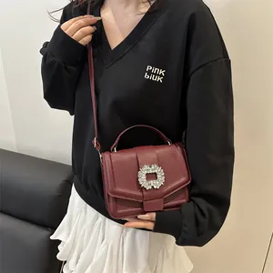 Elegant burgundy leather crossbody bag with sparkling rhinestone buckle for women