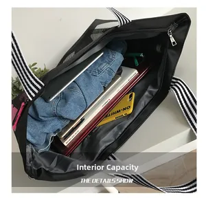 Interior view of black tote bag showing large capacity for laptop, books and essentials
