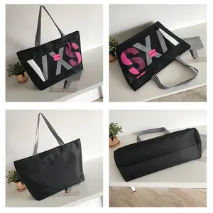 Detailed four-angle view of large black tote bag featuring pink VXS lettering and striped straps