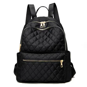 Classic black quilted backpack with gold metal zippers and large capacity compartments
