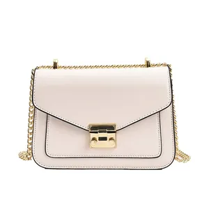 Minimalist light pink crossbody chain bag with golden rectangular clasp and V-flap design