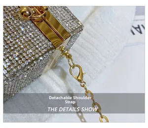 Close-up of detachable gold chain strap on a luxury rhinestone evening clutch bag