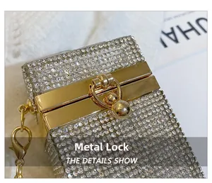 Detailed close-up of the sparkling crystal evening bag with golden hardware clasp