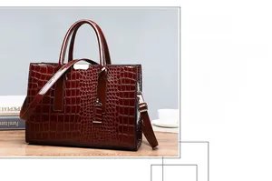 Close-up of crocodile textured faux leather handbag with elegant metallic accents