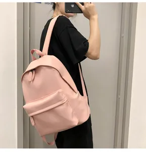 Pink PU leather backpack featuring adjustable straps and a spacious front zipper pocket
