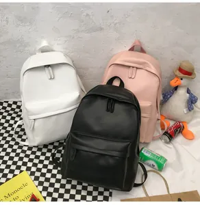 Three minimalist PU leather backpacks in black, white, and pink shown in a lifestyle setting