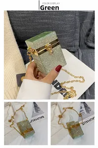 Detail of green rhinestone box clutch bag with gold chain strap and crystal finish