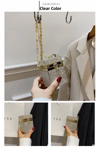 Detail of silver rhinestone mini box bag with gold metal trim and elegant chain strap