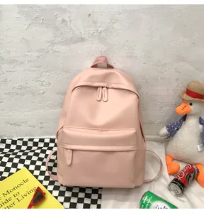 Detailed view of light pink minimalist PU leather backpack with dual zippers and front pocket