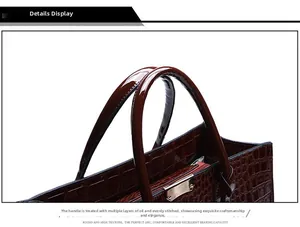 Detail of dark brown crocodile embossed leather texture with precise stitching