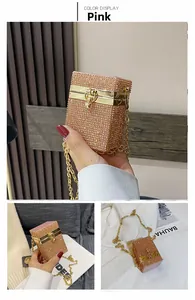 Detail view of pink rhinestone mini evening bag with gold chain and metal frame