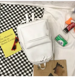White PU leather backpack detail showing front zipper pocket and matte texture