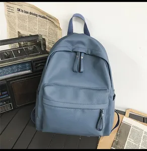 Detail of blue lychee texture PU leather backpack with front zipper pocket and retro vibe