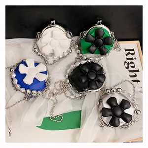 Detailed top view of mini crossbody flower bags in various colors with pearl chain straps