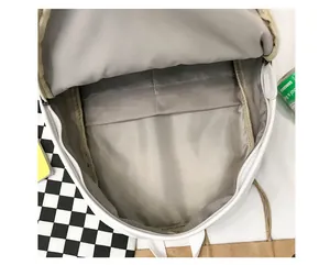 Detail view of the white PU leather backpack interior with functional organizer pockets