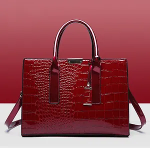 Deep red crocodile embossed tote bag with double handles and adjustable crossbody strap