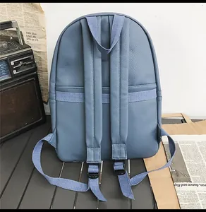 Detail of blue textured PU backpack back with adjustable straps and lychee leather grain