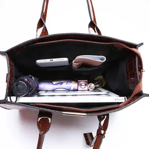 Deep brown crocodile embossed tote bag showcasing spacious interior and functional pockets