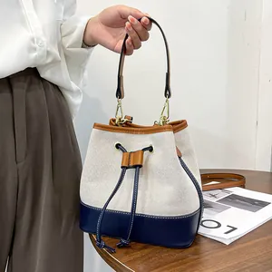 Canvas bucket bag with color-block stitching and adjustable shoulder strap for women